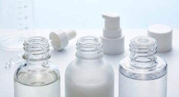 Cosmetic bottle neck finishes shown with a lotion pump, dropper and screw cap